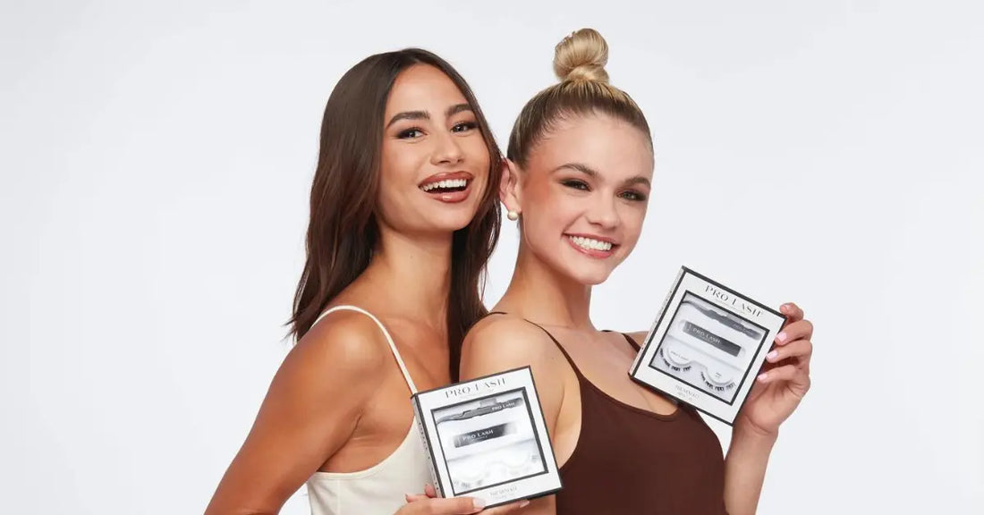 Eyelash extension kit held by two smiling women wearing tank tops against a white background