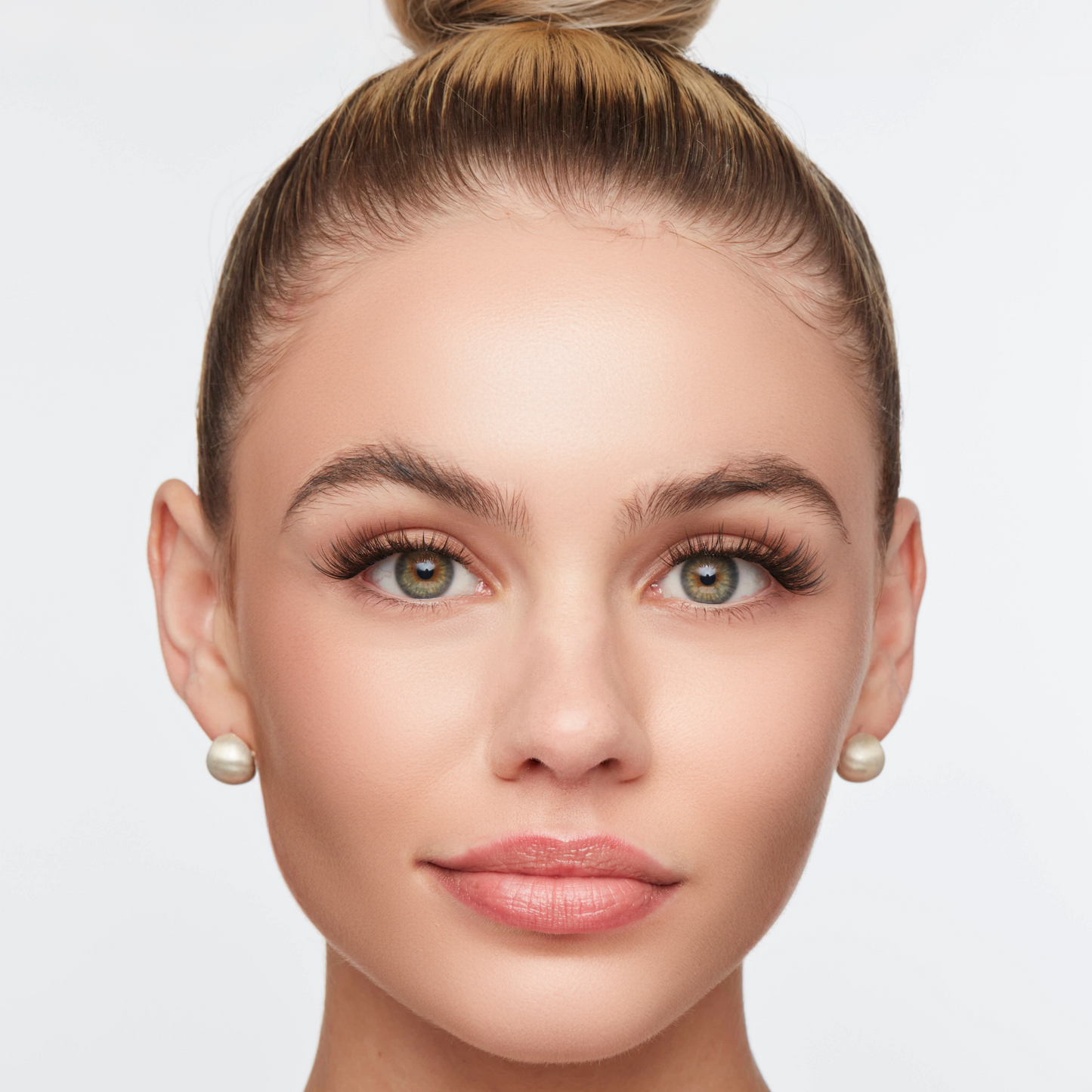 Classic wispy lashes styled on a woman with a polished look, featuring defined volume and soft, natural length