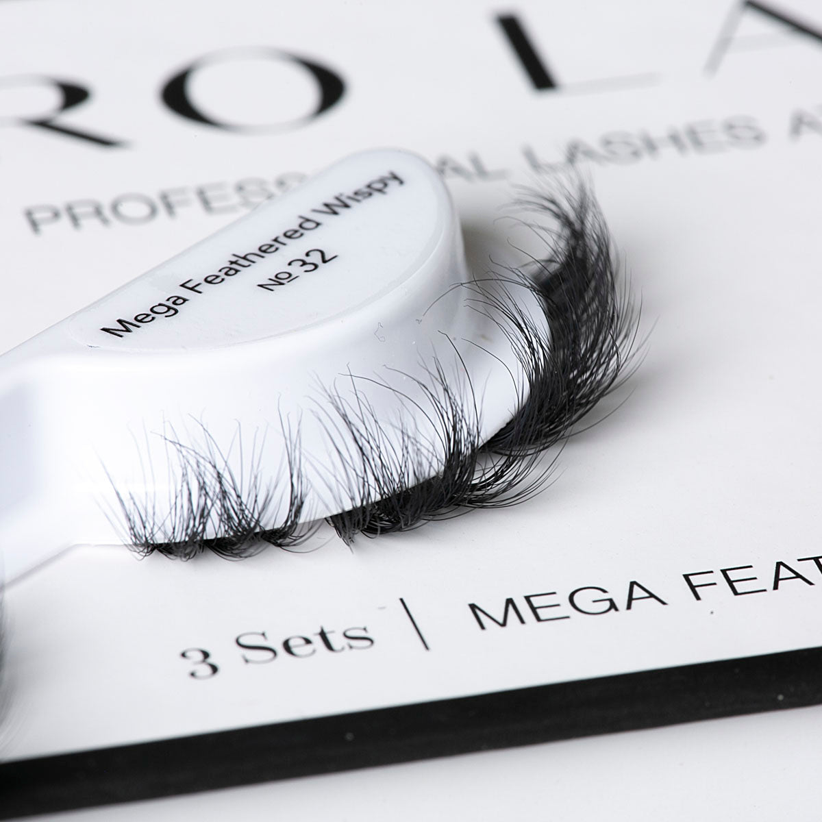 Feathered eyelash extensions in a Mega Feathered Wispy No.32 style with soft, voluminous curls for a dramatic look