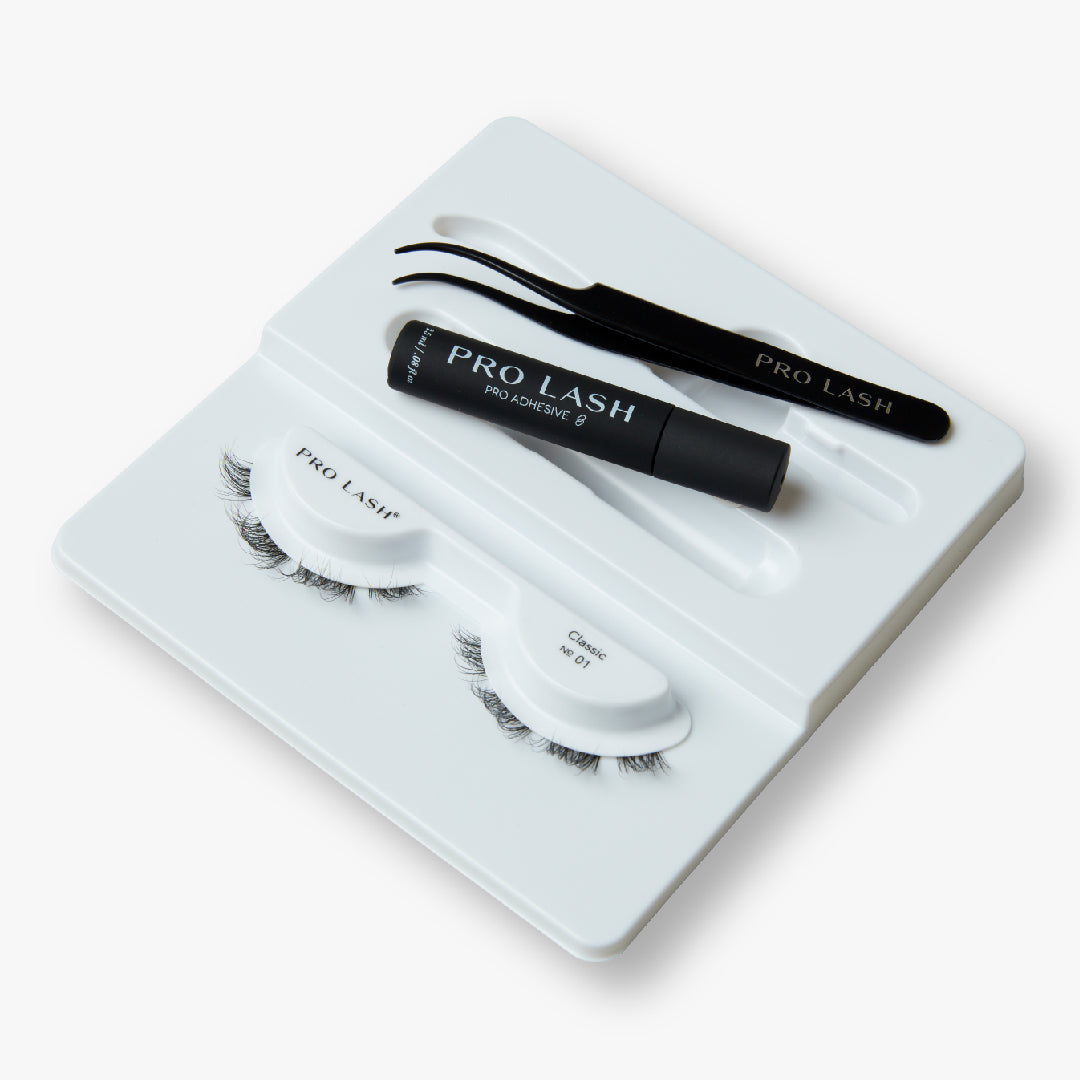 Eyelash extension kit for beginners featuring Pro Lash Classic No. 01 lashes, adhesive, and tweezers for easy application.