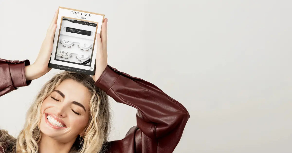 3D volume lashes Pro Lash kit held overhead by a smiling woman, showcasing dramatic lash options.
