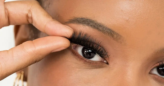 Long-lasting eyelash extensions being applied for a secure, natural-looking fit on the upper lash line.