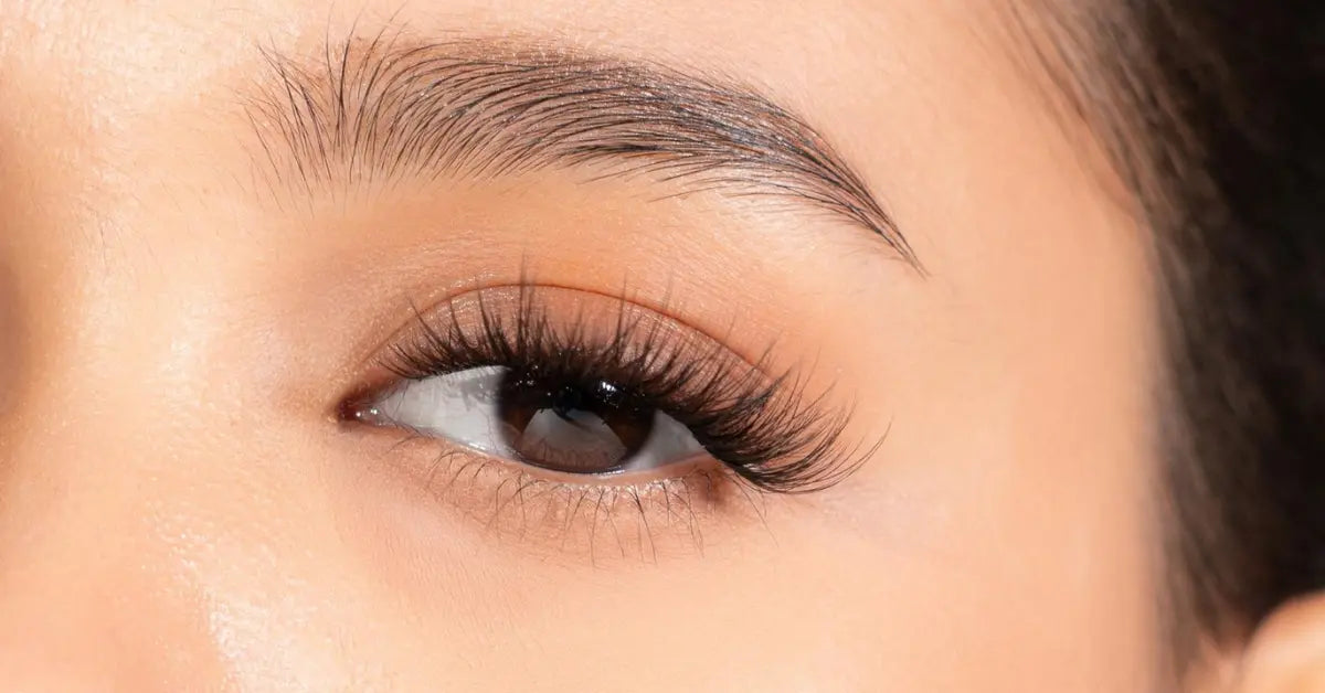 Lashes shown in a close-up of fluffy, natural-looking eyelash extensions