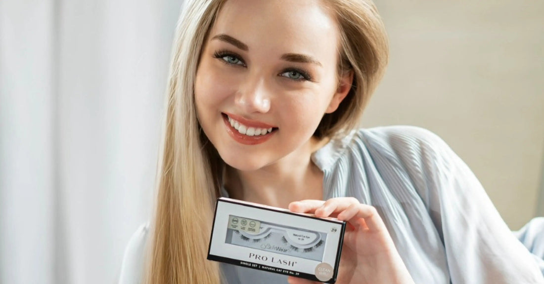 Cost of lash extensions represented by a smiling model holding a Pro Lash box, emphasizing an affordable alternative to salon lash services.