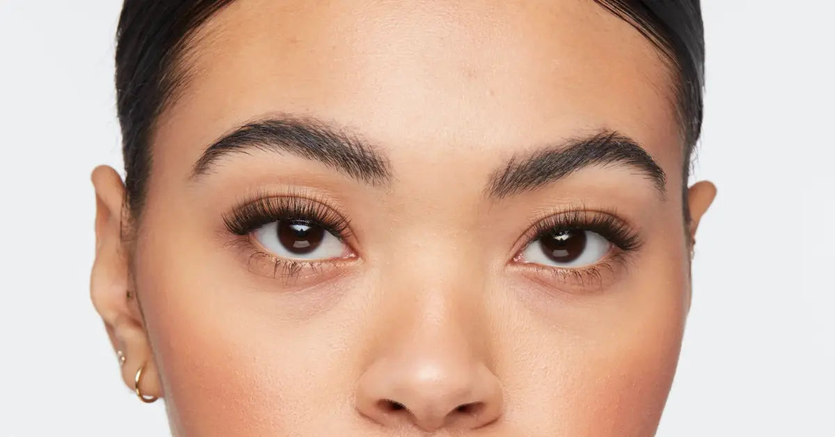 Eyelash extensions on woman’s eyes with natural finish and clean makeup, emphasizing enhanced lash length and curl