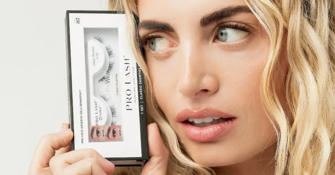 Lash extension at-home kit held beside face, featuring Pro Lash classic collection packaging.