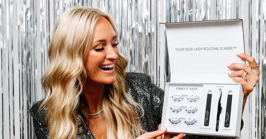 Wispy lashes kit from Pro Lash shown by smiling woman in sparkly outfit against silver backdrop.