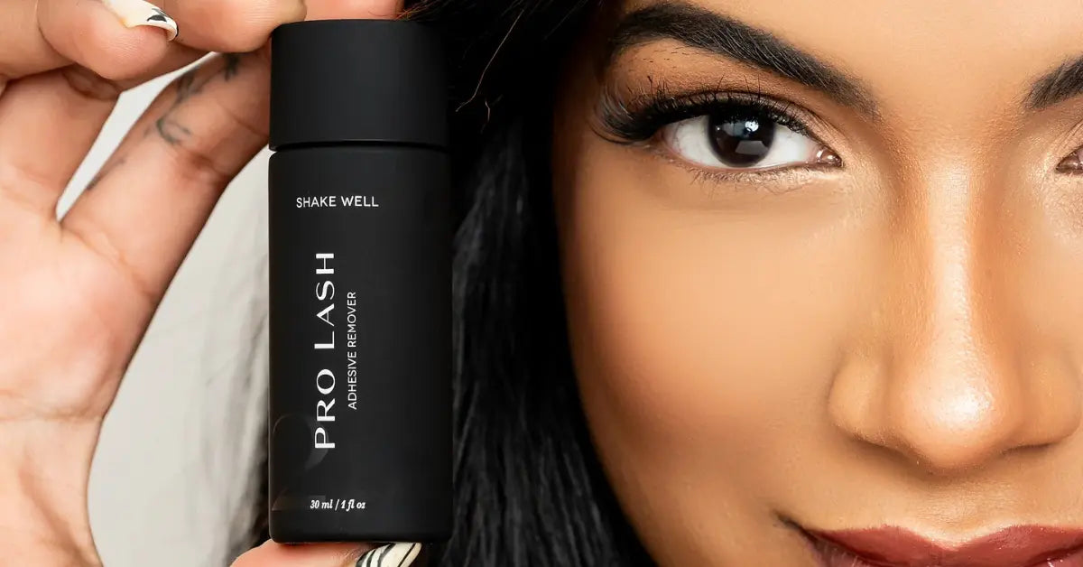 Tools for DIY lash extensions including Pro Lash adhesive remover held beside woman's eye with full lashes.