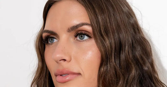 Mega volume lash extensions on woman with softly contoured makeup