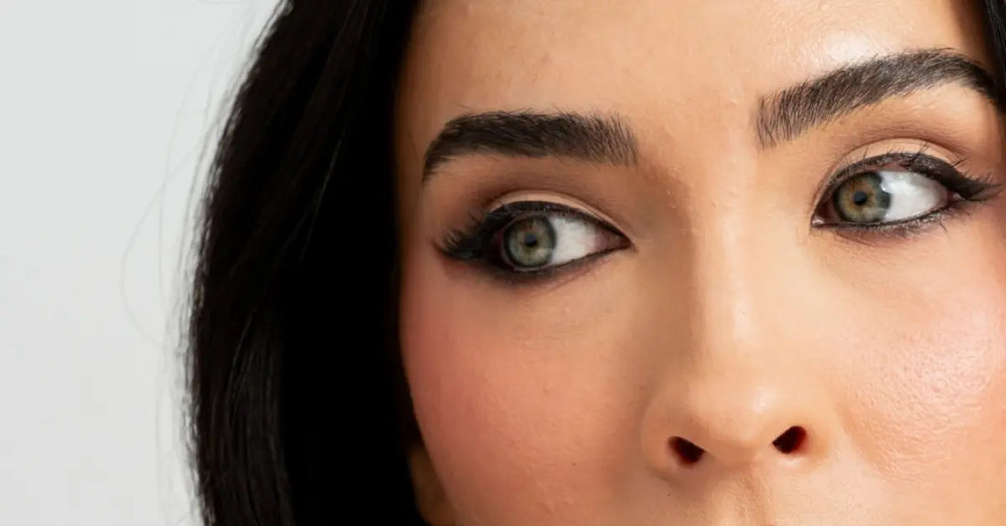 Natural-looking lash extensions shown on a model with soft, full lashes and subtle makeup