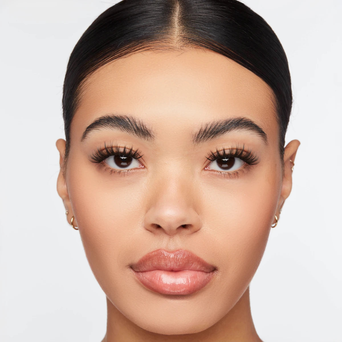 Volume wispy eyelash extensions on model with full, feathered lashes that enhance eye shape for a soft glam look.