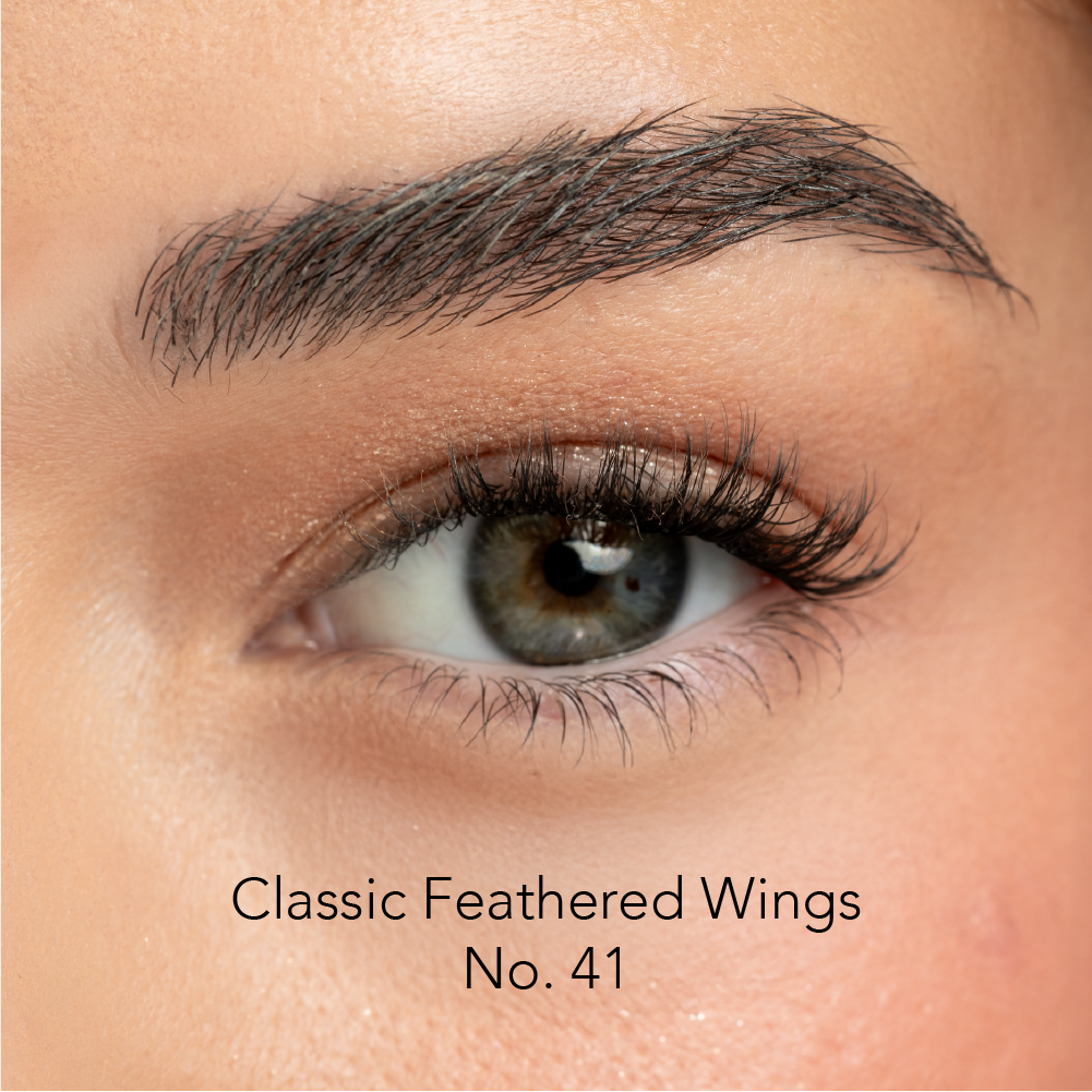 Close-up of an eye with false eyelashes labeled 'Classic Feathered Wings No. 41'.