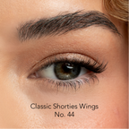 Close-up of an eye with false eyelashes labeled 'Classic Shorties Wings No. 44'.