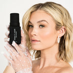 At home eyelash extension prep with woman holding Pro Lash Prep Cleanser while wearing sheer polka dot gloves.