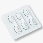 Volume wispy lashes in the Luxe Shortie No. 30 style are displayed in three curved trays on a white holder, designed for easy, reusable application.