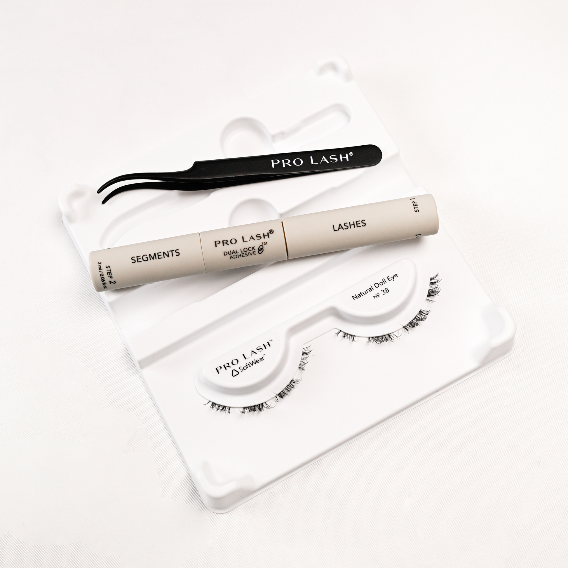 Eyelash extension kit with Pro Lash segments, adhesive, tweezers, and Natural Doll Eye No. 38 lashes.