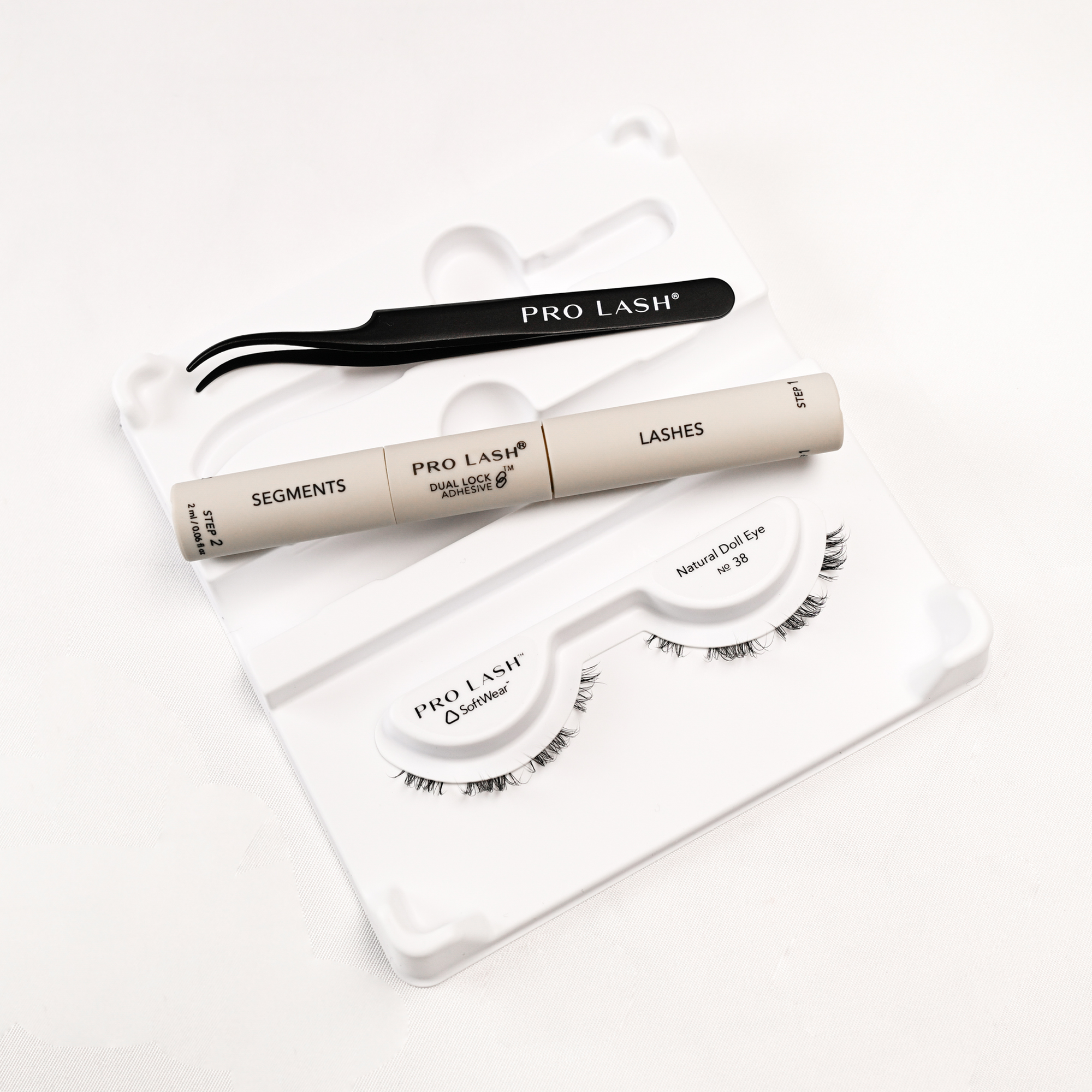 Eyelash extension kit with Pro Lash segments, adhesive, tweezers, and Natural Doll Eye No. 38 lashes.