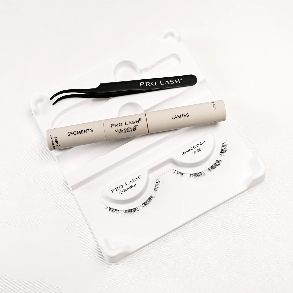 Eyelash extension kit with Pro Lash segments, adhesive, tweezers, and Natural Doll Eye No. 38 lashes.