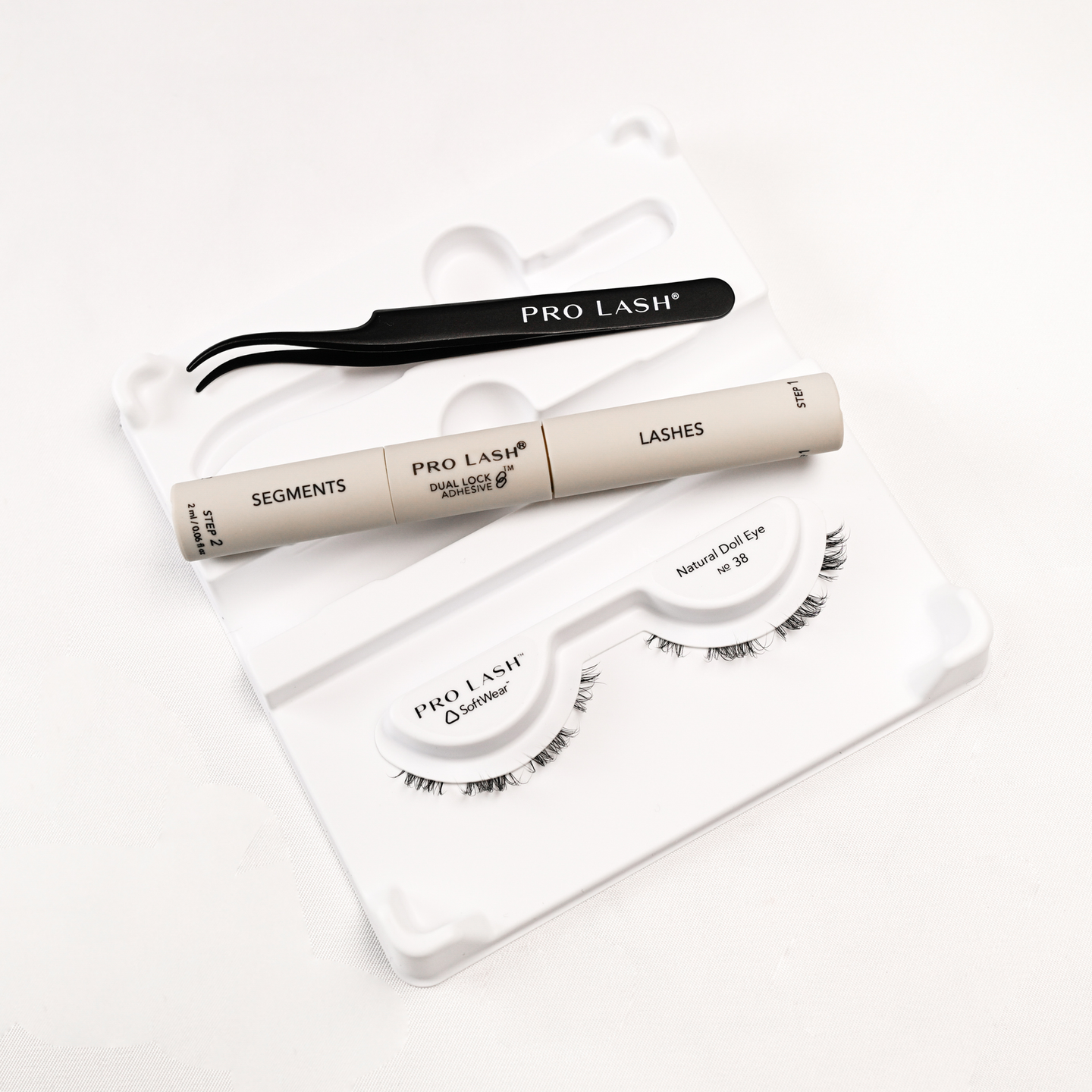 Eyelash extension kit with Pro Lash segments, adhesive, tweezers, and Natural Doll Eye No. 38 lashes.